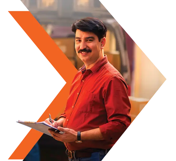 Bank representative holding documents and smiling while assisting a customer.