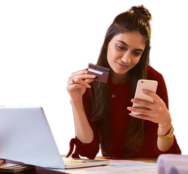 Woman holding a credit card and using a smartphone for online banking or payment.