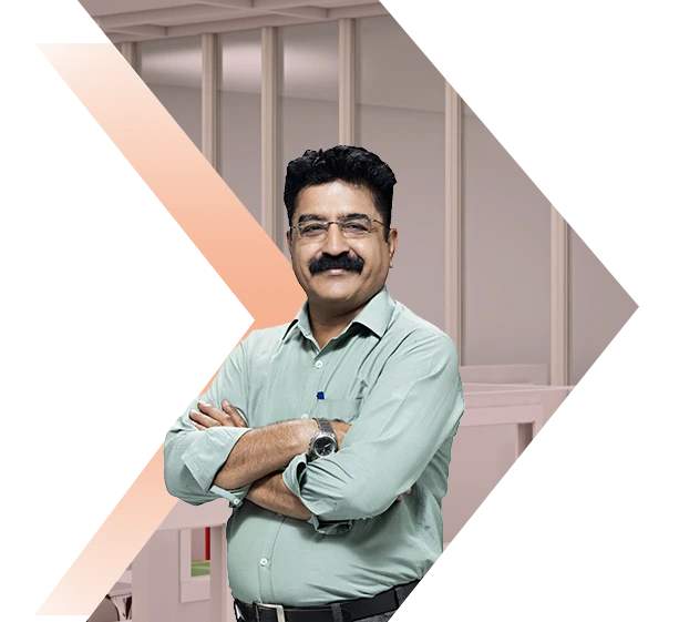 Man with moustache standing with arms crossed against orange backdrop