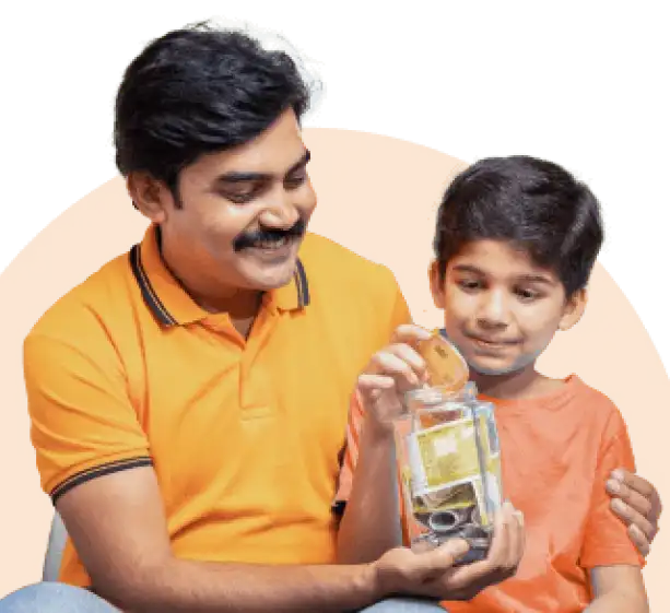 Father and son smiling as the child drops a coin into a transparent savings jar filled with money.