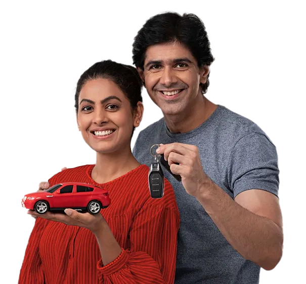 Smiling couple holding card keys against orange background.