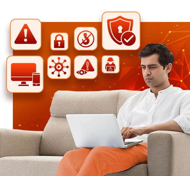 Man using a laptop an a sofa with online banking security icons displayed on an ICICI Bank webpage.