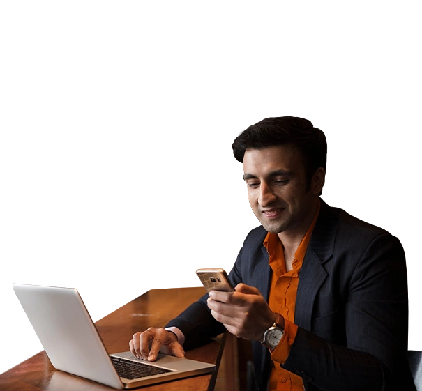Man using laptop and smartphone against orange background.
