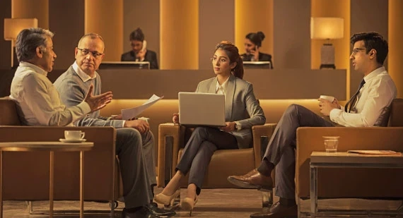 Banner for NRI Private Banking Programme showing advisors meeting clients in a lounge setting.
