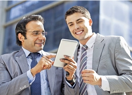 Two businessmen discussing documents in office.